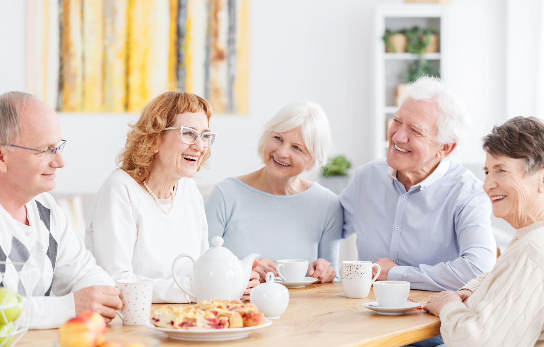 Group of happy older people on a meeting in senior club